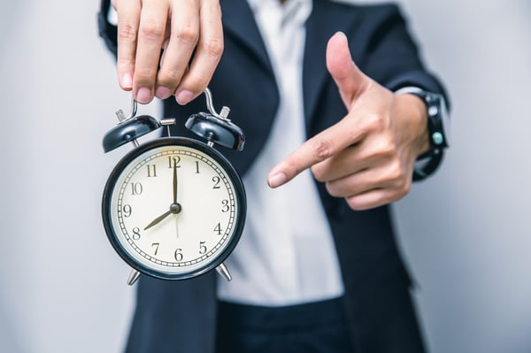 Man with clock showing urgency 